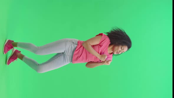 Portrait of Young Female African American Cheerfully Dancing Dance of Victory Joy or Good Mood