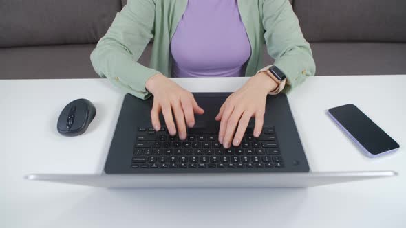 Entrepreneur woman typing text on notebook computer at home in 4k footage
