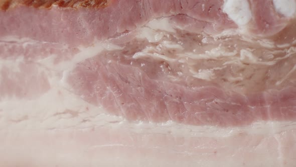 Panning on smoked  pork meat product close-up 4K 2160p 30fps UltraHD footage - Cured bacon  unhelath