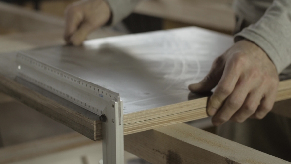 Woodworker Put Two Equal Wooden Boards Under Metal Straightedge. Furniture