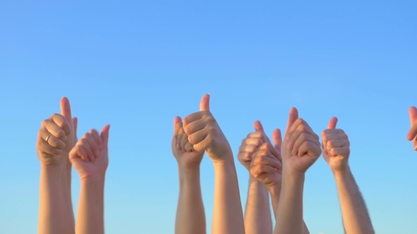 Hands Up With Thumbs-up Against Blue Sky