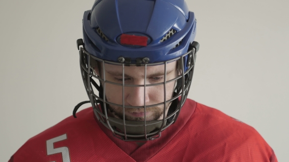 Portrait Of a Hockey Player In Helmet Against White Backround