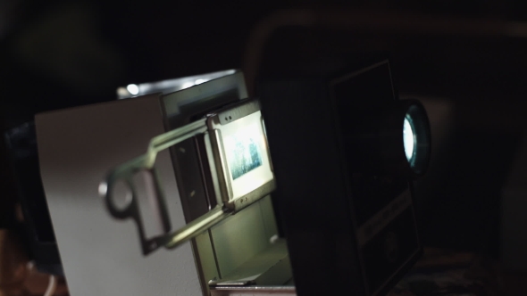 Man Shows Photos On The Slide Projector  alt