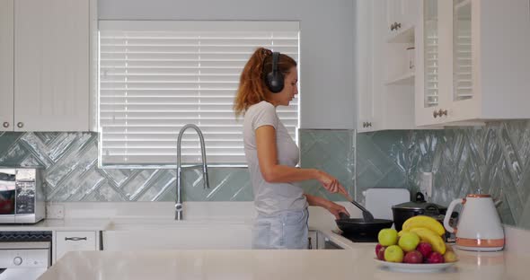 Portrait of Cheerful Woman Singing Song in Whisker on Domestic Kitchen in Slow Motion