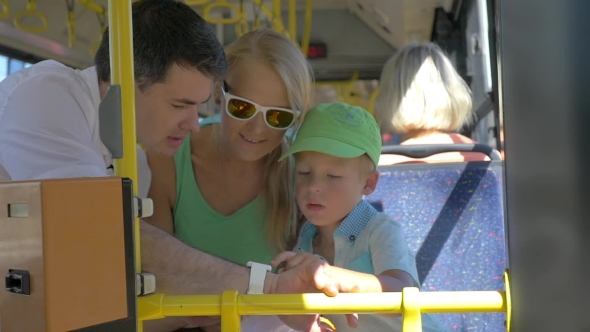 Son And Mother Using Dads Smartwatch In The Bus