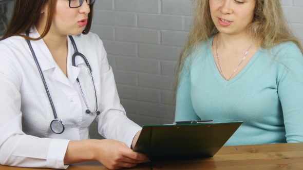 Doctor Explaining Diagnosis To Her Female Patient