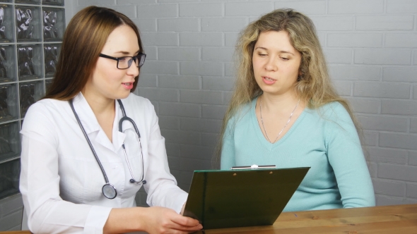 Doctor Explaining Diagnosis To Her Female Patient