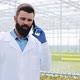 Agricultural Engineer in a Greenhouse Using Mobile, Talking on Smartphone - VideoHive Item for Sale