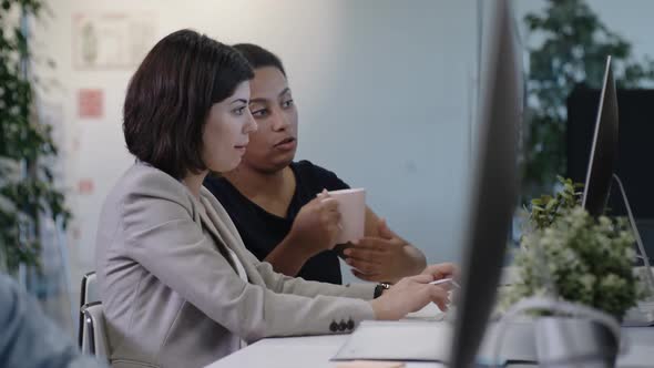 Female Colleagues Working in Office