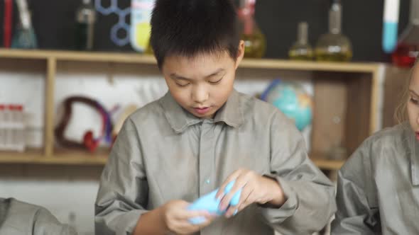 Laboratory Experience in a Chemistry Lesson, Kids Playing with a Multicolored Slime, Children's