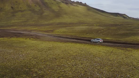 Car rides on a dirt road. Iceland landscape.