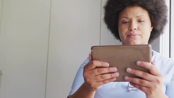 Video of focusedplus size african american female doctor using tablet