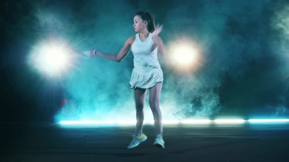 Young Lady is Hitting a Tennis Ball While Playing