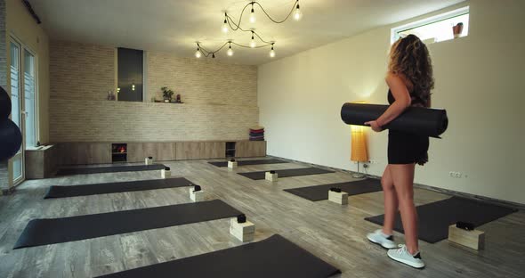 In a Modern Wellness Yoga Studio Woman Walking