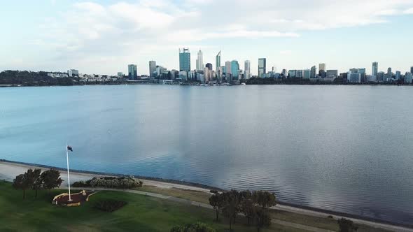 Aerial panoramic of Australian flag pole next to water, Perth city skyline in background