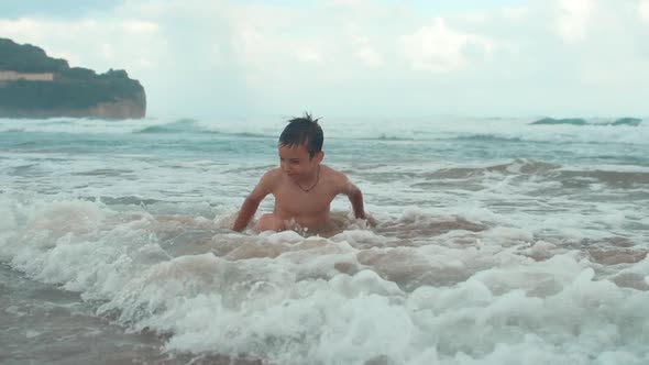 Cheerful Boy Spending Time at Seashore