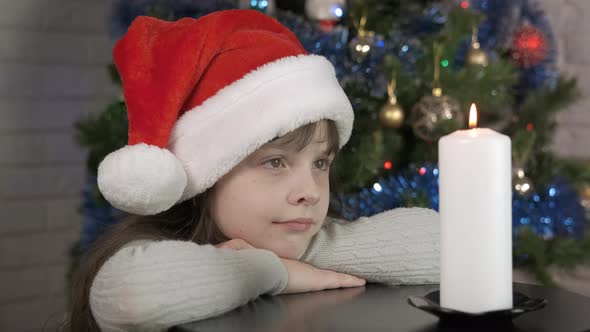 Sad Alone Child By Christmas Candle