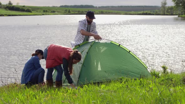 Family on Vacation Sets Up a Tent in Nature