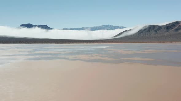 Death Valley Desert with High Black Mountains Covered By Thick Fog Clouds, 