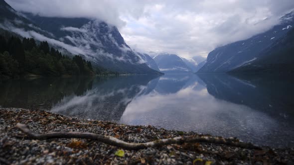 Slider Time Lapse of Beautiful Norwegian Lake (Lovatnet) with Moving Clouds Reflecting in the Still