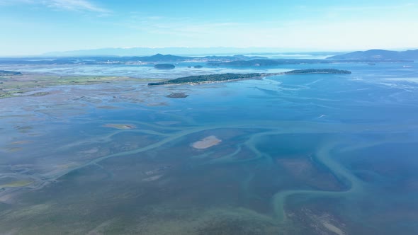 Aerial shot over Samish Bay in Washington with the San Juan Islands off in the distance.