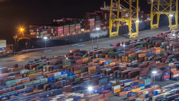 Seaport and Loading Docks at the Port with Cranes and Multi-colored Cargo Containers Night Timelapse
