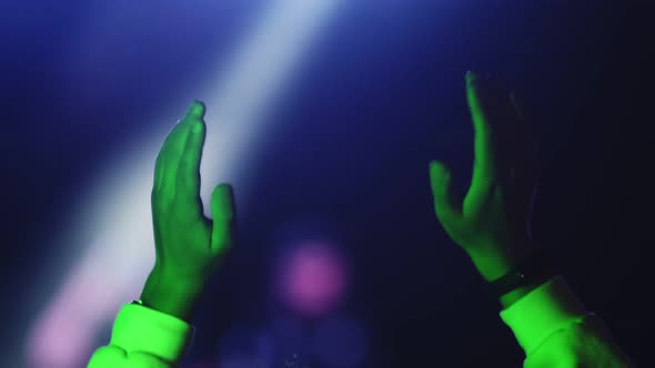 Young Man Raised His Hands Up and Jumps Up Rejoicing and Having Fun at an Openair Concert Closeup