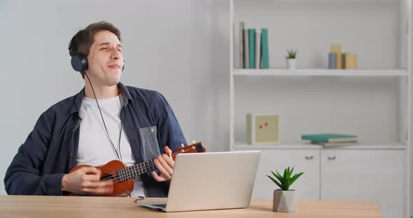 Funny Business Man with Headphones Having Fun at Home Workplace Listening to Music Happy Manager