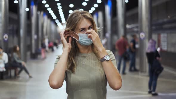 Woman Puts Mask in Subway Look at Camera Corona Virus. Passenger Metro Covid-19.