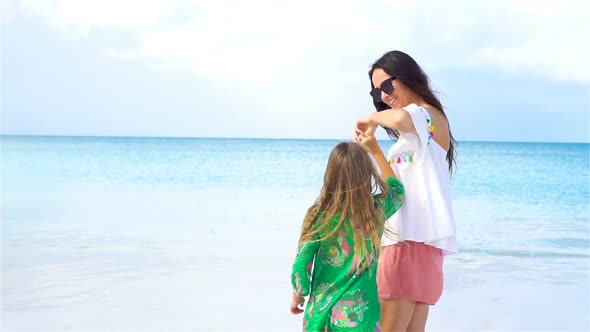 Little Girl and Young Mother on the Beach Hava Lot of Fun Together