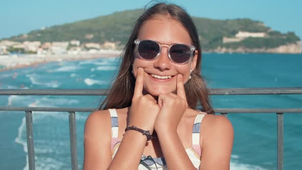 Smiling Girl Enjoying Holiday at Seaside