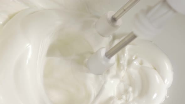 Hand mixing egg whites with mixer close-up 4K 2160p UHD footage - Mixing egg whites with electric mi