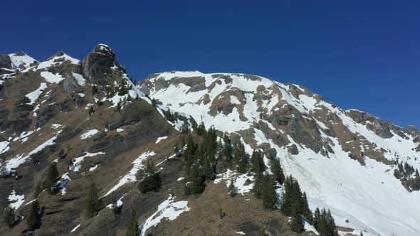 Cinematic aerial of snow covered mountain ridge