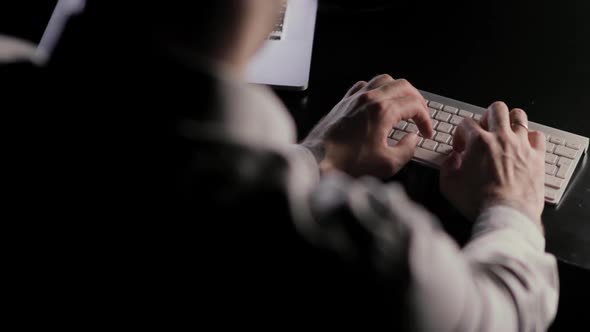 Man's Hands Typing on the Keyboard Sitting at the Table on Workplace.