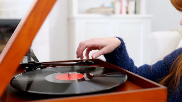 Beautiful woman listening music on turntable 