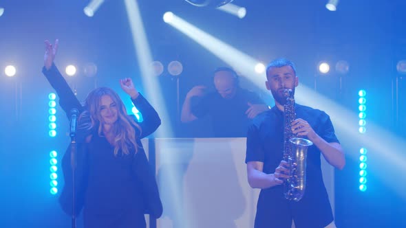 Musical Band Group of Three People Playing Music Song Performing on Concert Musician Light Stage