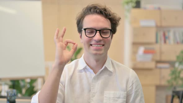 Portrait of Young Man Showing OK Sign