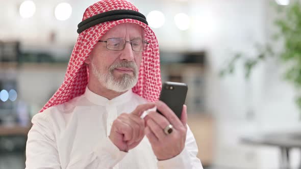 Attractive Senior Old Arab Businessman Using Smartphone 