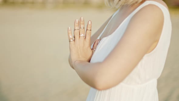 Woman Practicing Yoga, Namaste Gratitude Mudra Alone on Sand Beach at Summer Sunset Time. Girl in alt