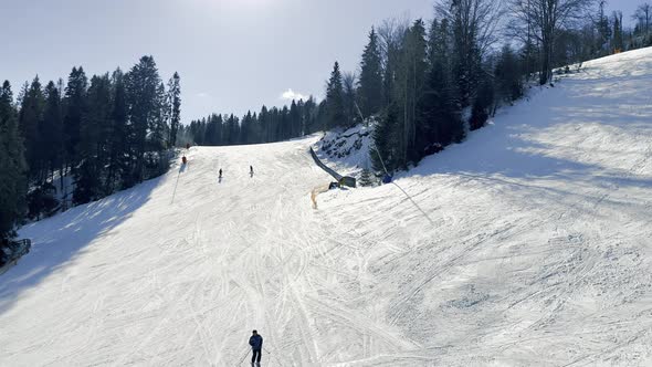 Skier Skiing Downhill in Winter Resort Mountains
