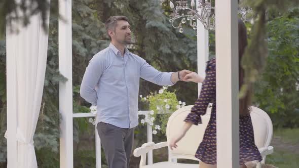 Middle Shot of Loving Caucasian Couple Dancing and Kissing on Summer Day Outdoors. Portrait of Happy