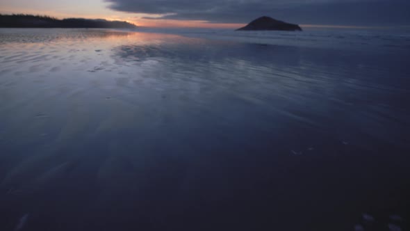 Spectacular Morning light reflections in wet sand at Long beach in Tofino, Canada