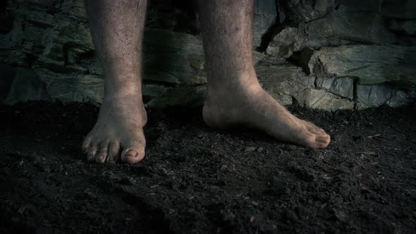 Barefoot Man Walks Around On Earth Floor