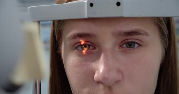 Young Woman Having Her Eyes Examined With Modern Medical Equipment