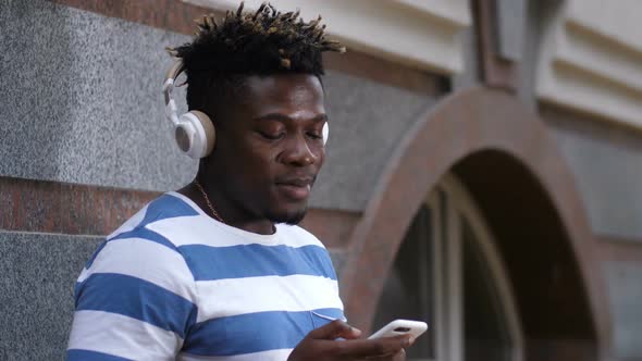 Good Looking Black Man Listening Music on Street