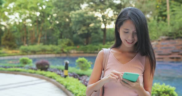 Woman use of cellphone in the park