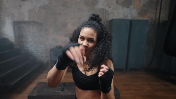 African American Female Boxer Fights with Wrapped Hands