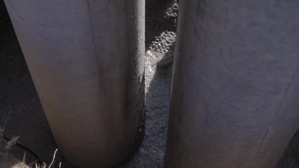 Fresh Concrete in a Pit Between Two Big Tubes Construction Site Footage