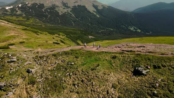 A Tourist Group Stands on Top of a Mountain