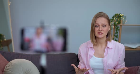 Emotional Female Social Media Influencer Talking and Gesturing While Looking To Smartphone Camera